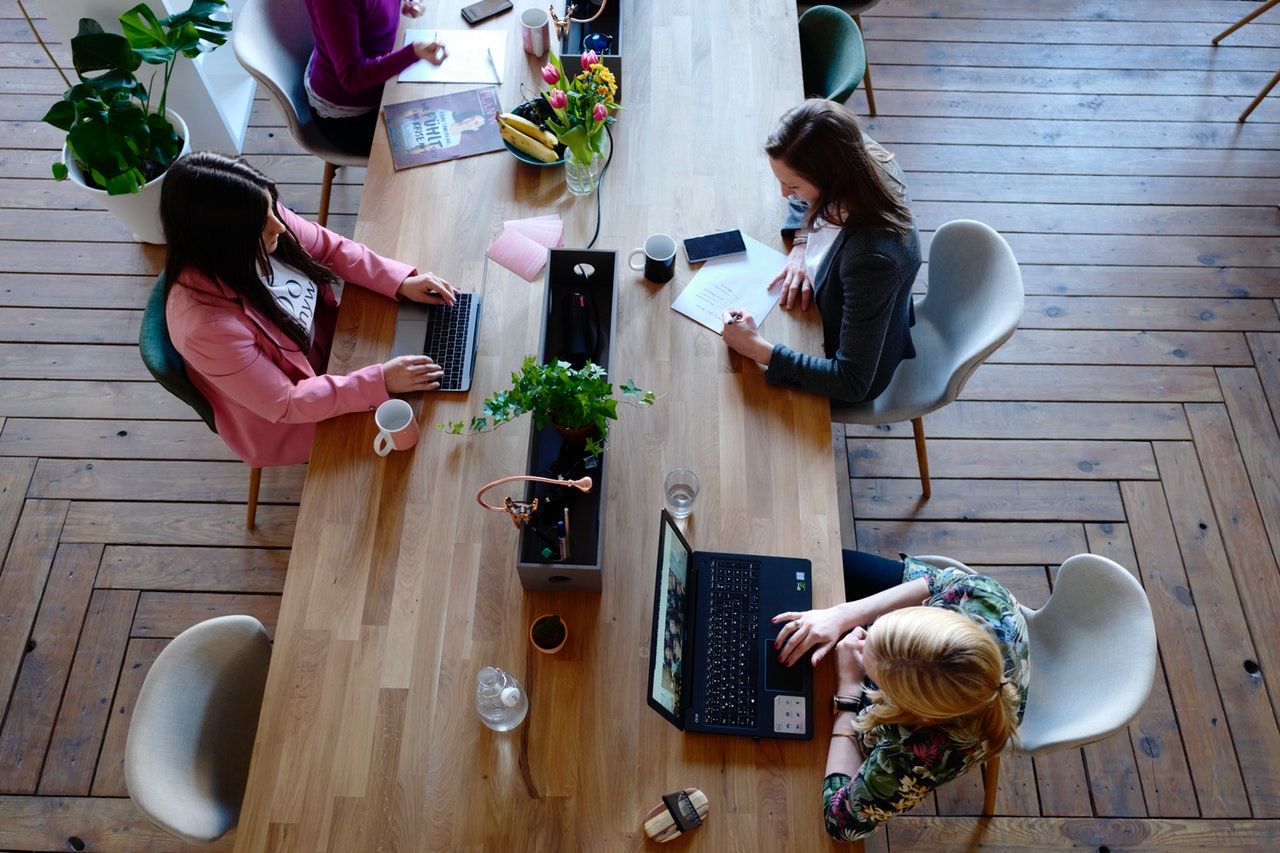 three-woman-sitting-on-white-chair-in-front-of-table-2041627 three-woman-sitting-on-white-chair-in-front-of-table-2041627